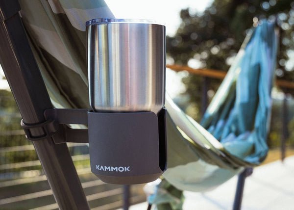 Kammok cup holder attached to a hammock stand swiftlet with a blurred outdoor background